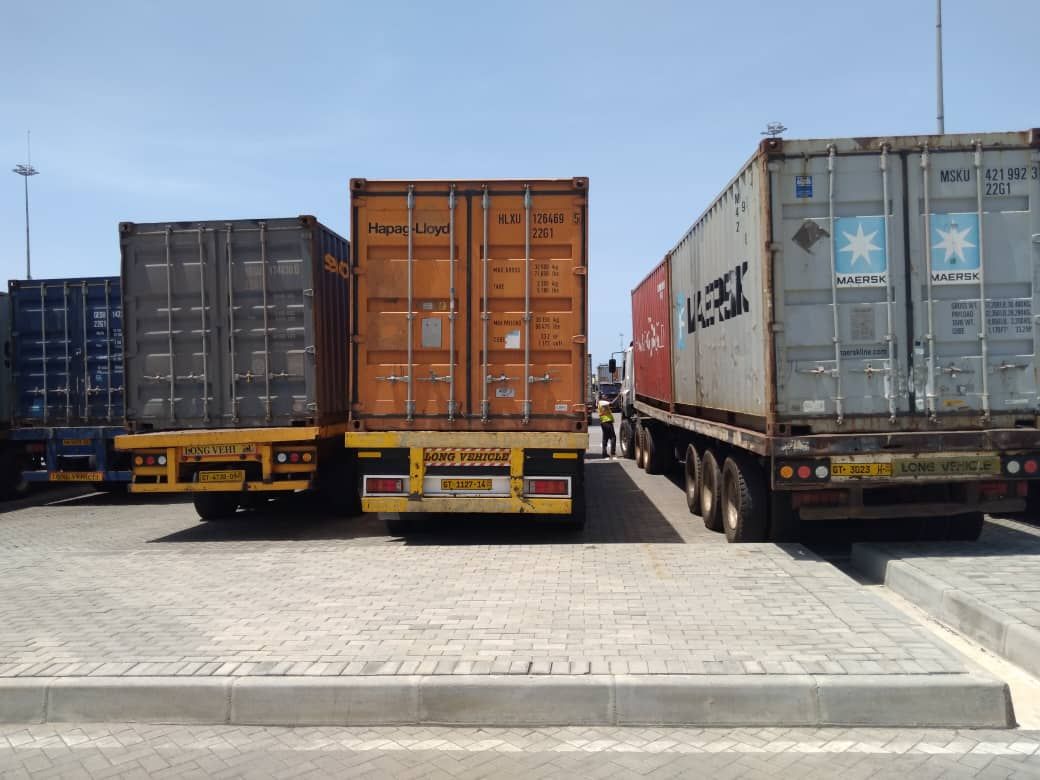 Shipping containers on trailers parked at a container terminal