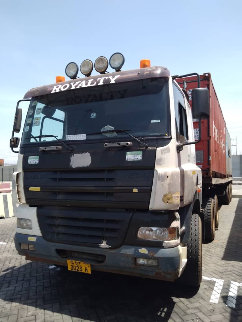 A DAF tractor unit hauling a red container